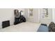 Bright bedroom with neutral carpet and walls, two windows, and a gray futon at 6252 Selborn Sw Dr, Atlanta, GA 30331