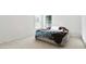 A bright bedroom with neutral walls and carpet, with a brown and blue comforter on the bed by the windows at 6252 Selborn Sw Dr, Atlanta, GA 30331