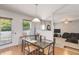 Casual dining area with modern table set and access to outdoor area, adjacent to open living space at 6252 Selborn Sw Dr, Atlanta, GA 30331