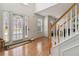 Bright foyer with wood floors, white trim, staircase and front door for welcoming guests and Gathering at 6252 Selborn Sw Dr, Atlanta, GA 30331