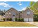 Traditional two-story brick home with a well-manicured lawn, double garage and classic architectural details at 6252 Selborn Sw Dr, Atlanta, GA 30331