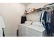 Functional laundry room with a white washer and dryer set, wire shelving, and essential laundry supplies at 6252 Selborn Sw Dr, Atlanta, GA 30331