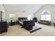 Large bedroom features vaulted ceilings, sitting area, and windows offering natural light. Dark wood furniture and neutral carpet at 6252 Selborn Sw Dr, Atlanta, GA 30331