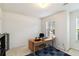 A clean, bright office space featuring a neutral color palette, a functional desk setup, and ample natural light from the window at 6252 Selborn Sw Dr, Atlanta, GA 30331