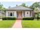 Inviting home exterior with a brick walkway, lush lawn, and charming curb appeal at 668 Peeples Sw St, Atlanta, GA 30310