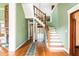 Bright foyer with hardwood floors, staircase, and a view into other rooms at 668 Peeples Sw St, Atlanta, GA 30310