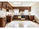 Outdated kitchen featuring dark wood cabinets, floral wallpaper, and tile flooring at 668 Peeples Sw St, Atlanta, GA 30310