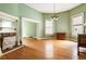Spacious living room boasts hardwood floors, a decorative fireplace, and windows providing great natural light at 668 Peeples Sw St, Atlanta, GA 30310