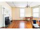 Cozy living room with large windows, hardwood floors, and a decorative fireplace making it welcoming at 668 Peeples Sw St, Atlanta, GA 30310