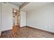 Spacious empty bedroom offers wood floors and a doorway to an ensuite bathroom with sliding doors at 943 Peachtree Ne St # 1010, Atlanta, GA 30309