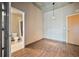 Cozy room with wood floors, ensuite bathroom entrance, and large doorway into the main living area at 943 Peachtree Ne St # 1010, Atlanta, GA 30309