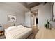 Relaxing bedroom provides a neutral color palette, wood floors, and an ensuite bathroom entrance at 943 Peachtree Ne St # 1010, Atlanta, GA 30309
