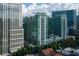 Exterior shot of high-rise building surrounded by lush trees in the downtown area at 943 Peachtree Ne St # 1010, Atlanta, GA 30309