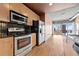 Updated kitchen boasts stainless steel appliances, wooden cabinetry, and a black tile backsplash at 943 Peachtree Ne St # 1010, Atlanta, GA 30309