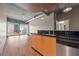 Bright living space features an open floor plan with hardwood floors and a balcony with city views at 943 Peachtree Ne St # 1010, Atlanta, GA 30309