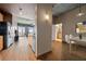 Open living space showcasing a modern kitchen, hardwood floors, and an entryway to a bathroom at 943 Peachtree Ne St # 1010, Atlanta, GA 30309