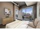 Sunny main bedroom includes wood floors and a balcony providing fantastic city views at 943 Peachtree Ne St # 1010, Atlanta, GA 30309