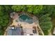 Aerial view of a backyard oasis with a freeform pool, spa, fire pit, lounge areas, and lush landscaping at 120 Burford Holw, Alpharetta, GA 30022