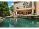 Spacious backyard with a pool, patio, and staircase, perfect for outdoor entertaining and relaxation at 120 Burford Holw, Alpharetta, GA 30022