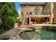 Backyard with a pool, spa, and stairs to the back of the house at 120 Burford Holw, Alpharetta, GA 30022