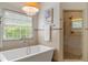 Bright bathroom with a soaking tub and a walk in shower at 120 Burford Holw, Alpharetta, GA 30022