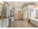 Elegant bathroom with a soaking tub, and marble floors at 120 Burford Holw, Alpharetta, GA 30022