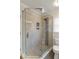 Bathroom featuring a tile shower with glass surround and tile floors at 120 Burford Holw, Alpharetta, GA 30022