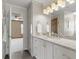 Bathroom featuring a granite vanity, built-in storage and bright lighting at 120 Burford Holw, Alpharetta, GA 30022