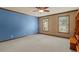 Spacious bedroom featuring carpeted floors, ceiling fan and two large windows at 120 Burford Holw, Alpharetta, GA 30022