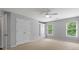 Bright bedroom with large windows, built-in wardrobe, ceiling fan and neutral decor at 120 Burford Holw, Alpharetta, GA 30022