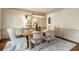 Cozy dining room with wood table, six chairs, overhead light, and neutral rug at 120 Burford Holw, Alpharetta, GA 30022