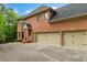 Lovely brick home with a three-car garage and well-manicured landscaping, offering curb appeal at 120 Burford Holw, Alpharetta, GA 30022