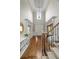 Bright, soaring foyer features hardwood floors, staircase, and elegant chandelier at 120 Burford Holw, Alpharetta, GA 30022