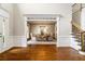 Elegant foyer with hardwood floors, staircase with iron balusters, and entry to the formal dining room at 120 Burford Holw, Alpharetta, GA 30022