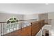Upstairs hallway showcasing hardwood floors, decorative railing, and a view of the foyer at 120 Burford Holw, Alpharetta, GA 30022