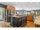 Well-equipped kitchen with stainless appliances, island with cooktop, and granite countertops at 120 Burford Holw, Alpharetta, GA 30022