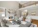 Bright living room with fireplace, hardwood floors, and a loft overlooking the room at 120 Burford Holw, Alpharetta, GA 30022
