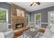 Cozy living area with a stone fireplace, large windows, and neutral decor at 120 Burford Holw, Alpharetta, GA 30022