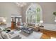 Spacious living room with tall ceilings, hardwood floors and large windows at 120 Burford Holw, Alpharetta, GA 30022