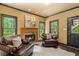 Relaxing living room with a fireplace, two leather chairs and a decorative rug at 120 Burford Holw, Alpharetta, GA 30022