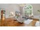 Cozy living room features hardwood floors, neutral colors and a large window at 120 Burford Holw, Alpharetta, GA 30022