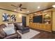 Cozy living room features a ceiling fan, a large built-in, and dark wood floors at 120 Burford Holw, Alpharetta, GA 30022