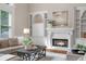Inviting living room featuring a fireplace, built-in shelving, and comfortable seating at 120 Burford Holw, Alpharetta, GA 30022