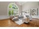 Spacious living room features a large window, fireplace, and built-in shelving at 120 Burford Holw, Alpharetta, GA 30022