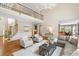 Bright living room with hardwood floors, comfortable seating, and open floor plan at 120 Burford Holw, Alpharetta, GA 30022