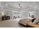 Spacious main bedroom suite boasts a trey ceiling and an attached sitting area at 120 Burford Holw, Alpharetta, GA 30022