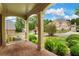 Inviting front porch with brick flooring, classic columns, a porch swing, and views of the landscaped yard at 120 Burford Holw, Alpharetta, GA 30022