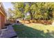 Large backyard with a mix of grass and bare spots, surrounded by a wooden fence for privacy at 2896 Toney Dr, Decatur, GA 30032