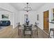 Dining room with chandelier, table set for four, wood flooring, and open to the living room at 2896 Toney Dr, Decatur, GA 30032