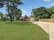 Expansive front yard leads up to a brick home with attached garage and long driveway at 2896 Toney Dr, Decatur, GA 30032